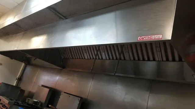 Commercial kitchen hood with compliance inspection sticker